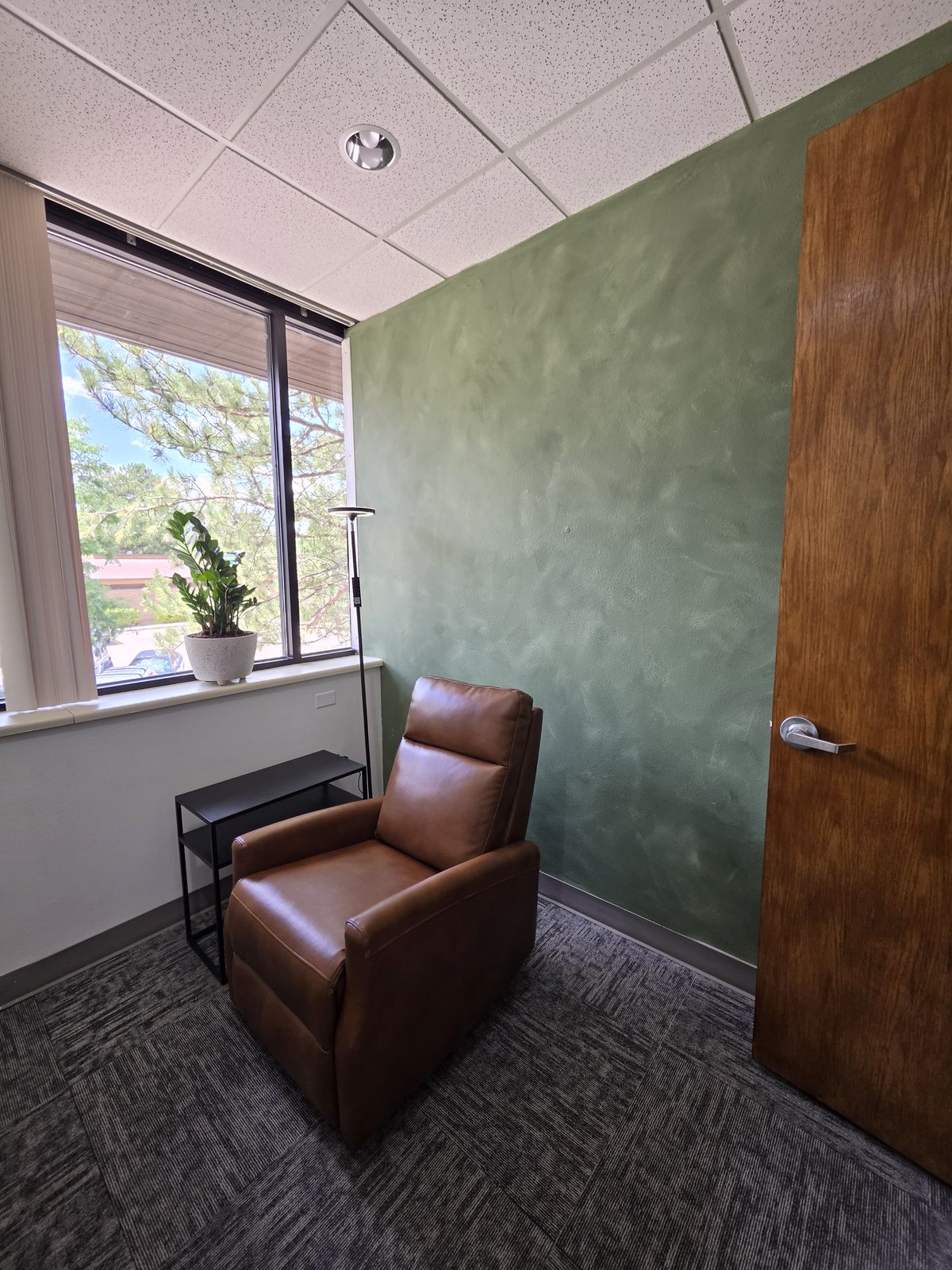 Private, comfortable Spravato treatment room at Fortifying Wellness in Littleton with a reclining chair and natural light